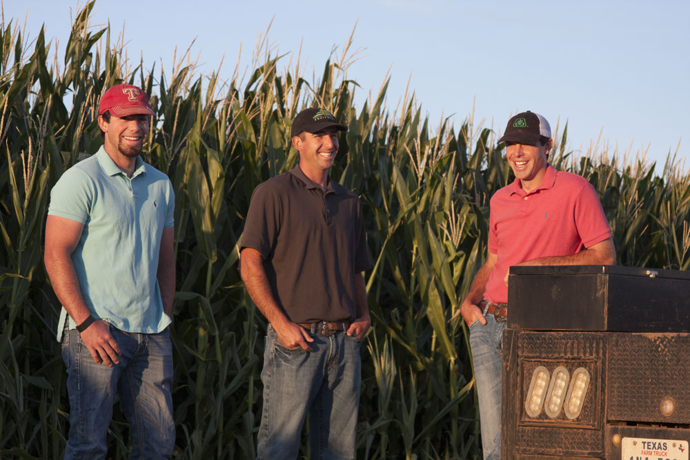 3 farmers in corn field