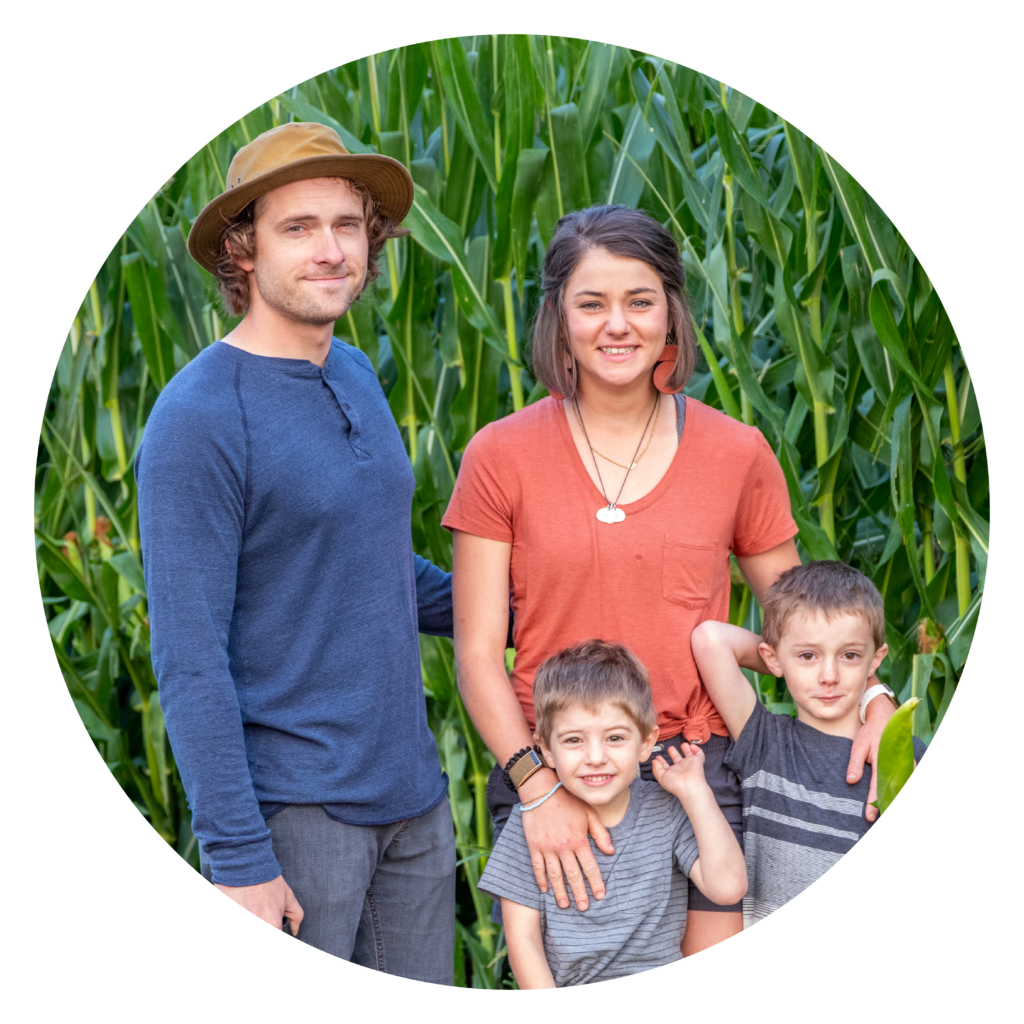The Howard family stand near a field at their farm.