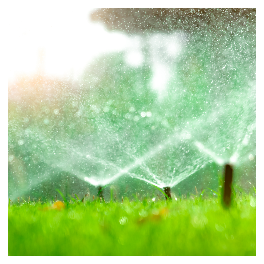 a residential irrigation system spraying water on a green lawn