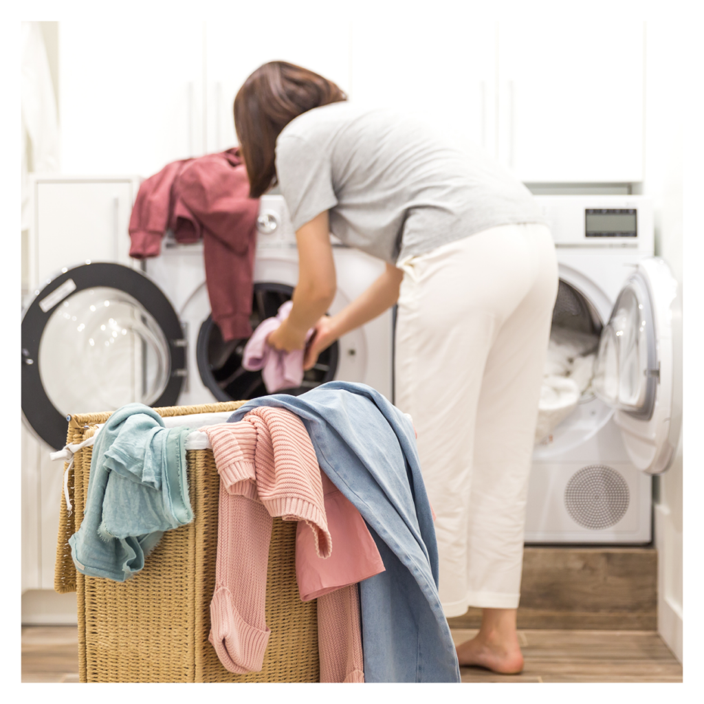 woman putting laundry into a washing machine