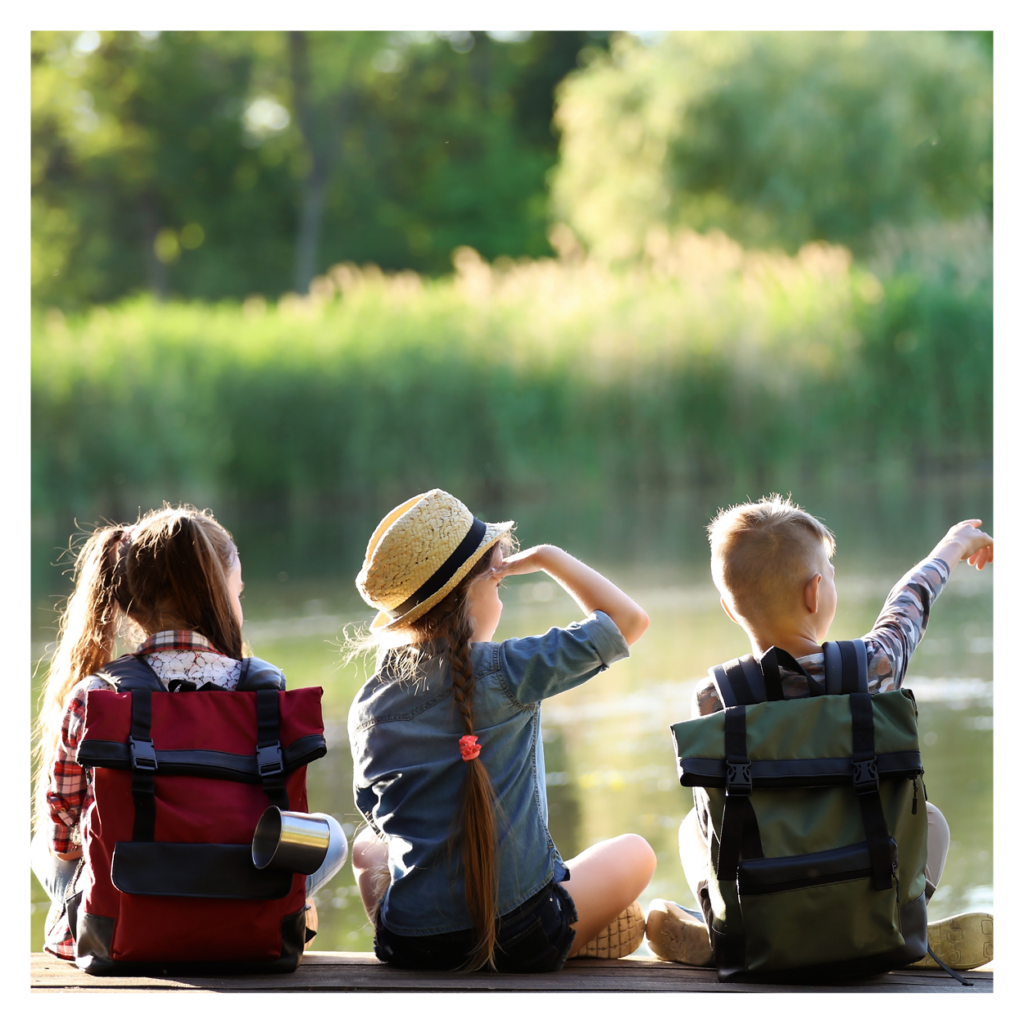 children looking at a pond