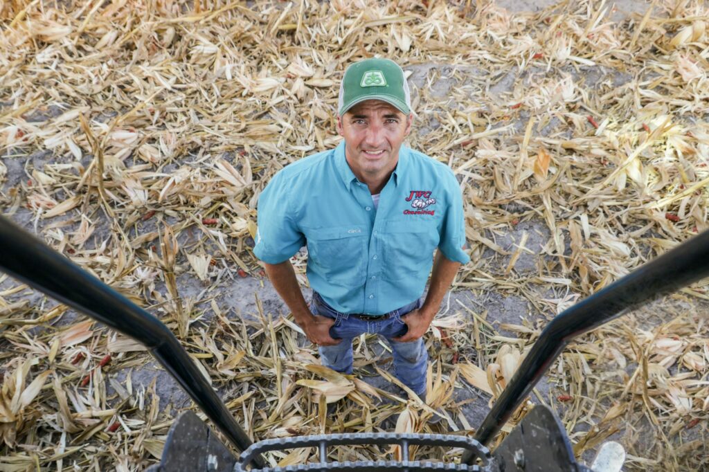 Texas farmer Colin Chopelas standing at the bottom of his combine's ladder.