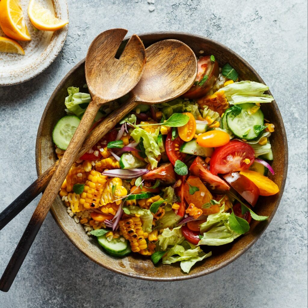 Delicious summer salad with various vegetables seasoned with sea salt and lemon.