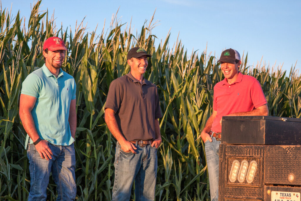 Farmers together in a corn field in Texas