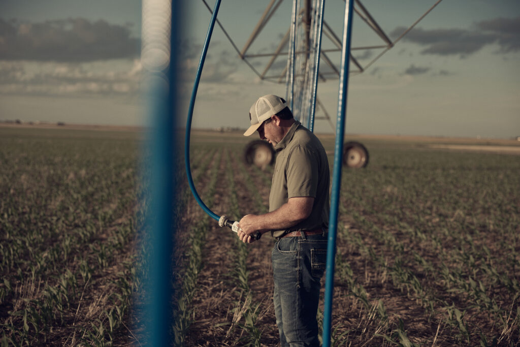 Texas Farmer Braden inspects his irrigation nozzles