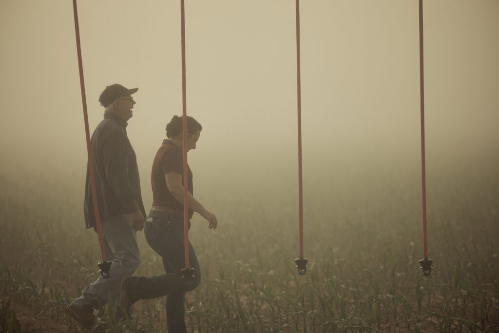 Farmer Craig and NRCS professional inspect his updated, efficient irrigation system